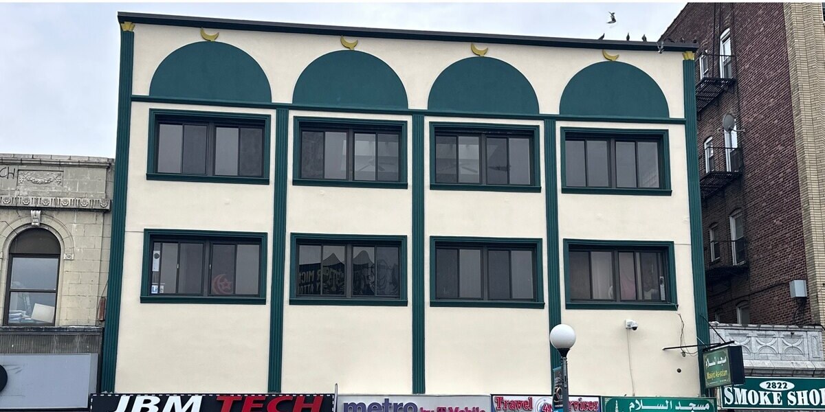 Completed commercial building exterior with restored gold accents