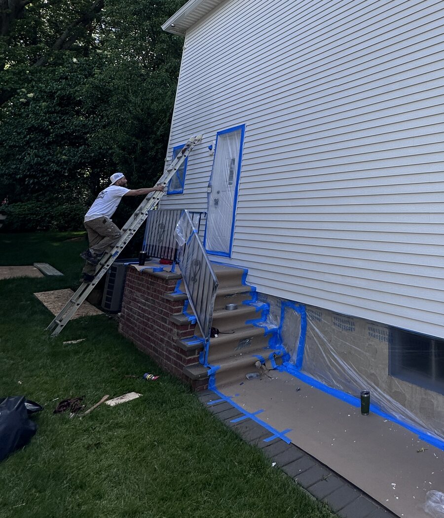 Dom working on a carefully protected residential exterior