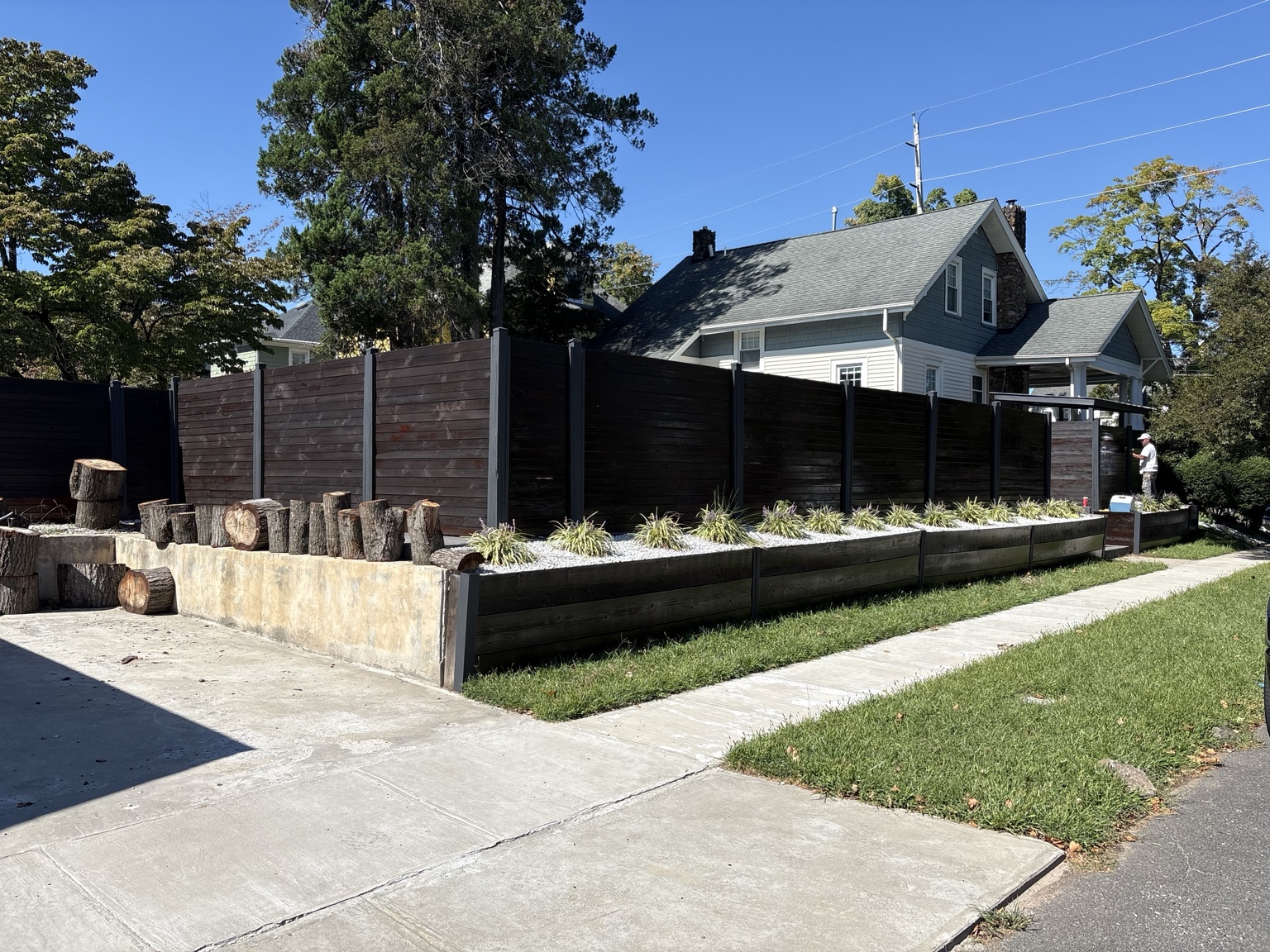 Wide completed view of a refinished residential wood fence