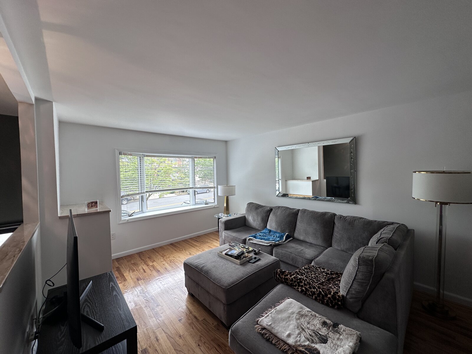 Finished residential living room with smooth walls, ceiling, and trim